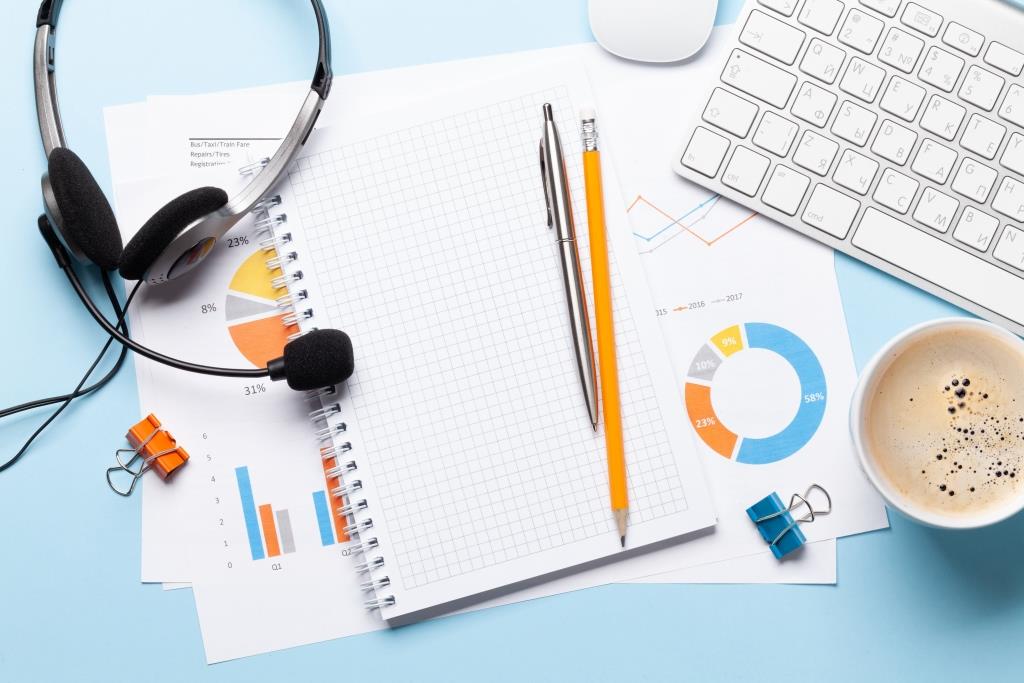 Office desk with headset and notepad